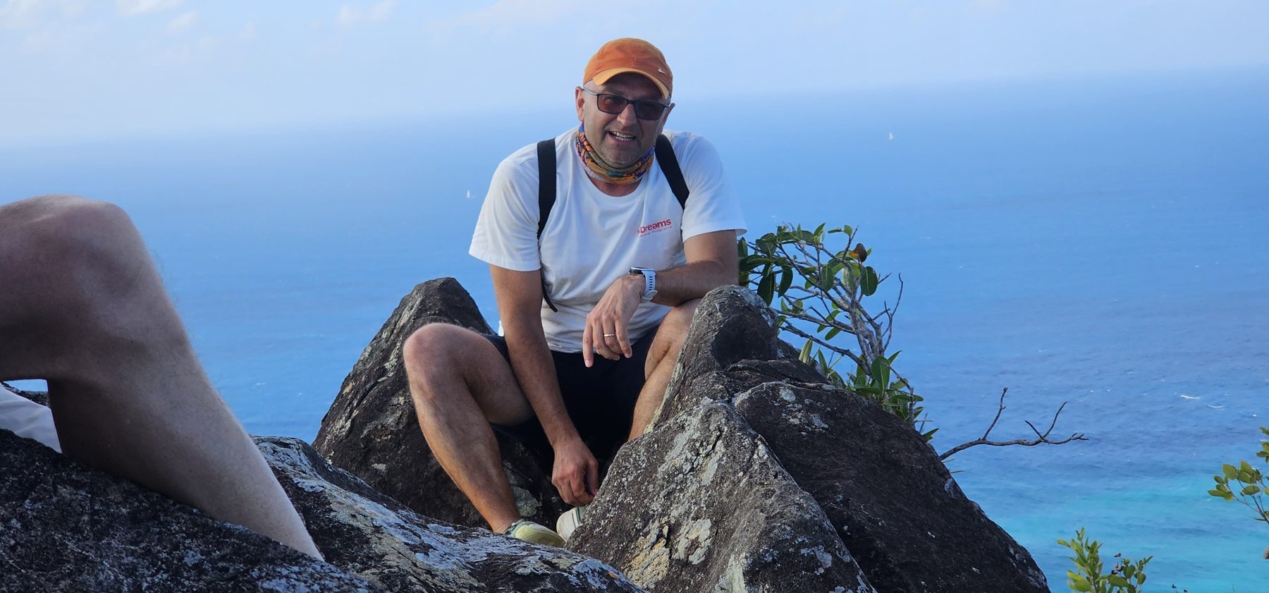 A guest takes in the view from the summit boulder